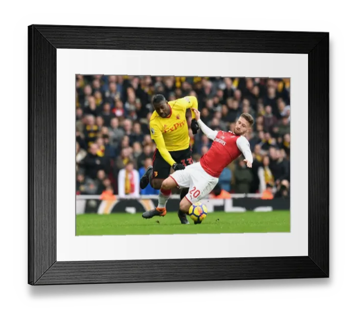 Framed Print : Mustafi vs. Okaka: Intense Clash between Arsenal's Defense and Watford's Forward in the Premier League