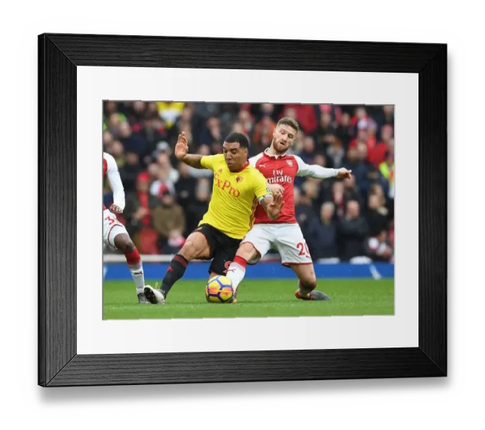 Framed Print : Mustafi vs. Deeney: Intense Clash Between Arsenal and Watford Players Framed Print : Mustafi vs. Deeney: Intense Clash Between Arsenal and Watford Players