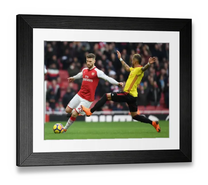 Framed Print : Mustafi vs Pereyra: Intense Clash Between Arsenal and Watford Players