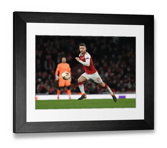 Framed Print : Shkodran Mustafi Focuses in Arsenal's Europa League Battle against AC Milan