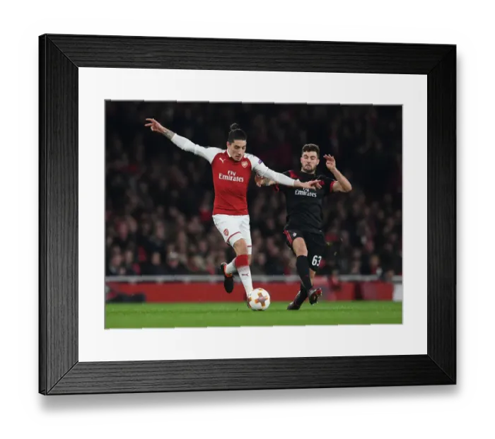 Framed Print : Arsenal's Hector Bellerin Clashes with AC Milan's Patrick Cutrone in Europa League Showdown