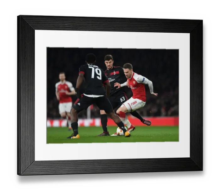 Framed Print : Arsenal vs AC Milan: Ramsey Stands Firm Against Cutrone and Kessie in Europa League Showdown