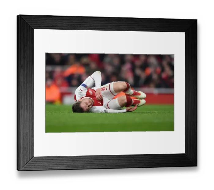 Framed Print : Aaron Ramsey's Injury Marrs Arsenal in Europa League Clash Against AC Milan