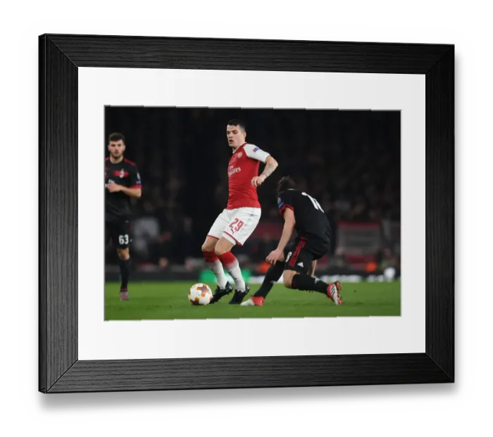Framed Print : Granit Xhaka: Arsenal's Midfield Maestro in Europa League Clash Against AC Milan Framed Print : Granit Xhaka: Arsenal's Midfield Maestro in Europa League Clash Against AC Milan