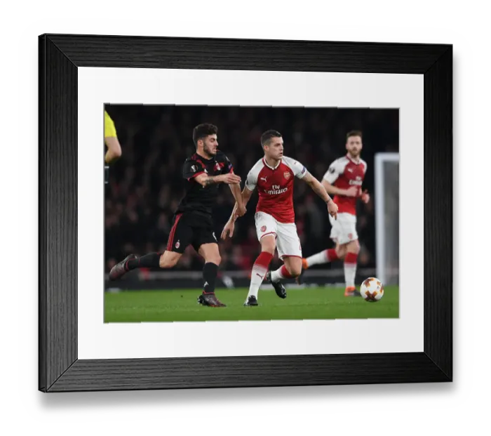 Framed Print : Xhaka vs. Cutrone: Battle in the Europa League as Arsenal Face Off Against AC Milan