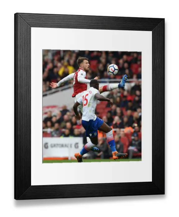 Framed Print : Arsenal's Ramsey Faces Off Against Stoke's Martin Indi in Intense Premier League Clash