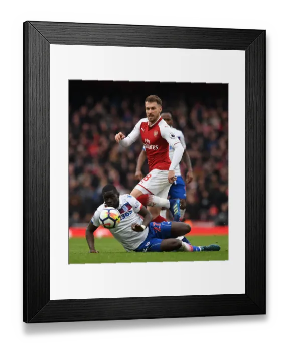 Framed Print : Arsenal's Aaron Ramsey Outmaneuvers Stoke's Badou Ndiaye during the Premier League Match Framed Print : Arsenal's Aaron Ramsey Outmaneuvers Stoke's Badou Ndiaye during the Premier League Match