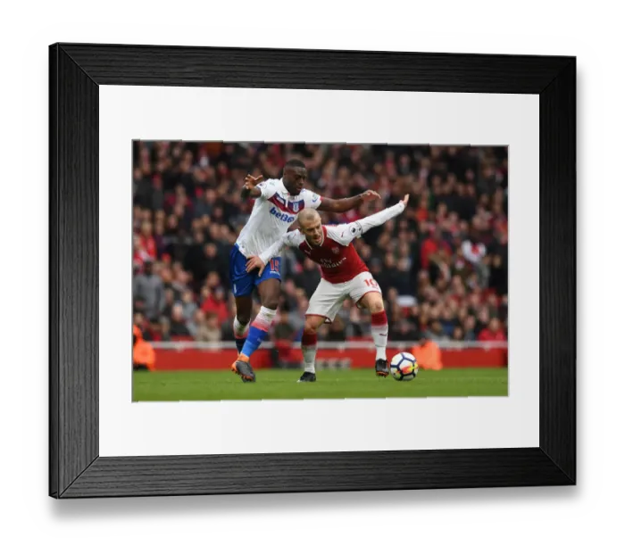 Framed Print : Arsenal's Jack Wilshere Faces Off Against Bruno Martins Indi in Intense Arsenal v Stoke City Clash Framed Print : Arsenal's Jack Wilshere Faces Off Against Bruno Martins Indi in Intense Arsenal v Stoke City Clash