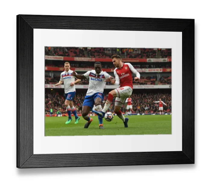 Framed Print : Arsenal's Aaron Ramsey Faces Off Against Stoke's Bruno Martins Indi in Intense Premier League Clash Framed Print : Arsenal's Aaron Ramsey Faces Off Against Stoke's Bruno Martins Indi in Intense Premier League Clash