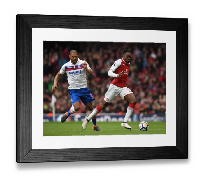 Framed Print : Arsenal's Danny Welbeck Faces Off Against Stoke's Glen Johnson in Premier League Clash Framed Print : Arsenal's Danny Welbeck Faces Off Against Stoke's Glen Johnson in Premier League Clash
