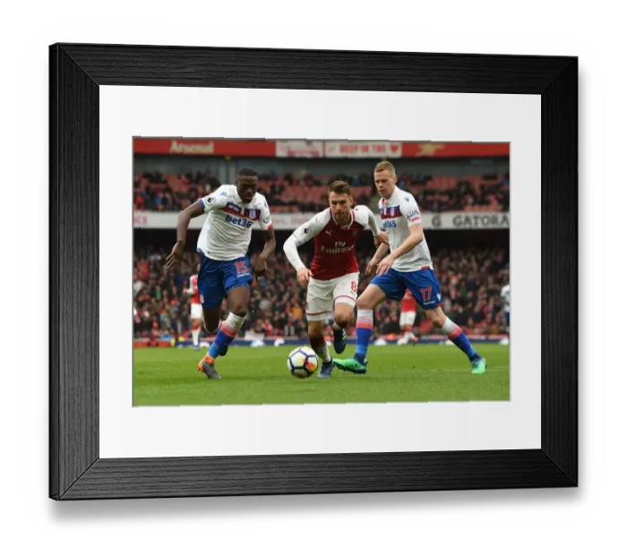 Framed Print : Arsenal's Aaron Ramsey Faces Off Against Bruno Martins Indi and Ryan Shawcross of Stoke City
