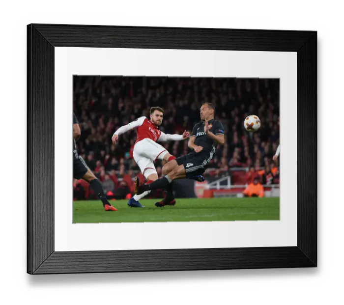 Framed Print : Arsenal's Aaron Ramsey Faces Off Against CSKA Moscow's Sergei Ignashevich in Europa League Quarterfinal Showdown