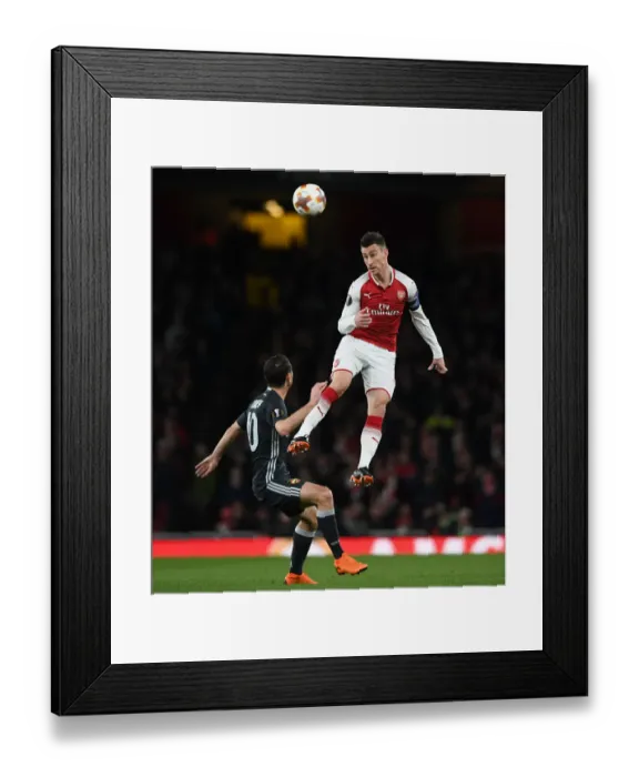 Framed Print : Clash of Heads: Koscielny vs. Dzagoev - Arsenal's Europa League Battle (Arsenal v CSKA Moscow 2017-18)