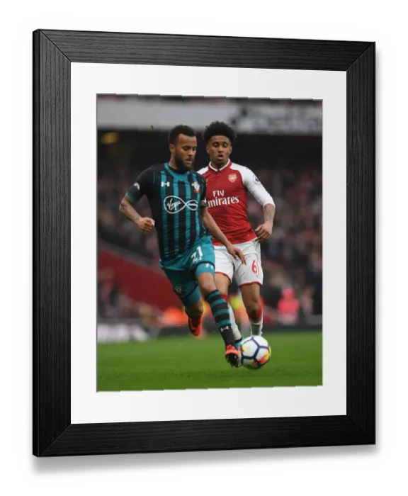 Framed Print : Arsenal's Reiss Nelson Closes In on Southampton's Ryan Bertrand in Intense Premier League Clash
