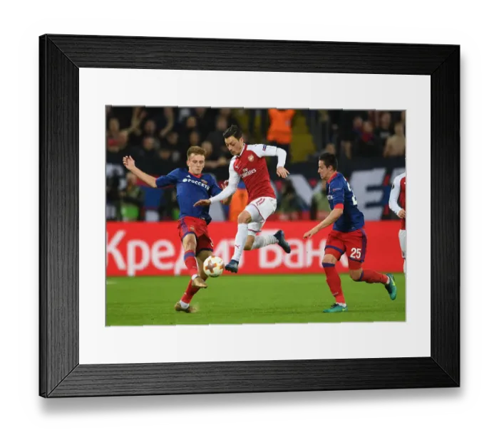 Framed Print : Mesut Ozil vs. Konstantin Kuchaev: A Battle in the Europa League Quarterfinals between CSKA Moscow and Arsenal FC Framed Print : Mesut Ozil vs. Konstantin Kuchaev: A Battle in the Europa League Quarterfinals between CSKA Moscow and Arsenal FC