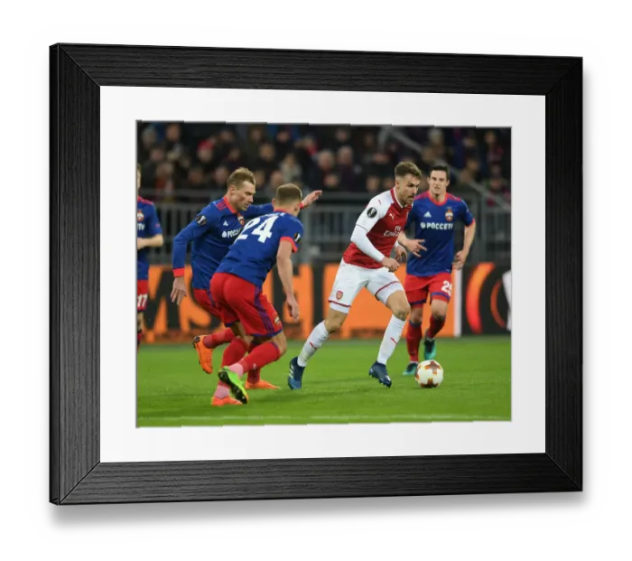 Framed Print : Arsenal's Aaron Ramsey Clashes with CSKA Moscow's Vasili Berezutski in Europa League Quarterfinal