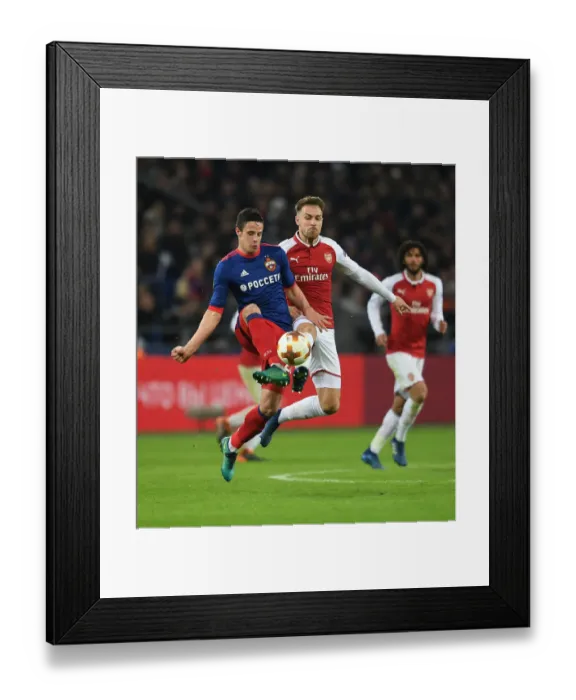 Framed Print : Arsenal's Aaron Ramsey Faces Off Against CSKA Moscow's Kristijan Bistrovic in Europa League Quarterfinal