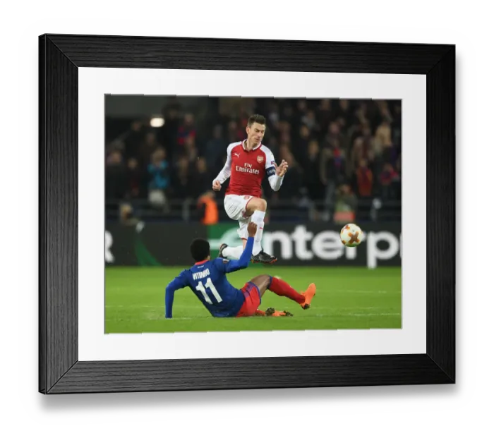 Framed Print : Arsenal's Laurent Koscielny Outmaneuvers Vitinho in UEFA Europa League Quarterfinal Clash