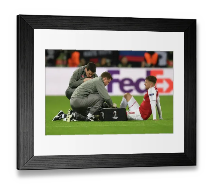 Framed Print : Arsenal's Aaron Ramsey Receives Medical Attention from Colin Lewin and Gary O'Driscoll during CSKA Moscow Match, UEFA Europa League 2018 Framed Print : Arsenal's Aaron Ramsey Receives Medical Attention from Colin Lewin and Gary O'Driscoll during CSKA Moscow Match, UEFA Europa League 2018