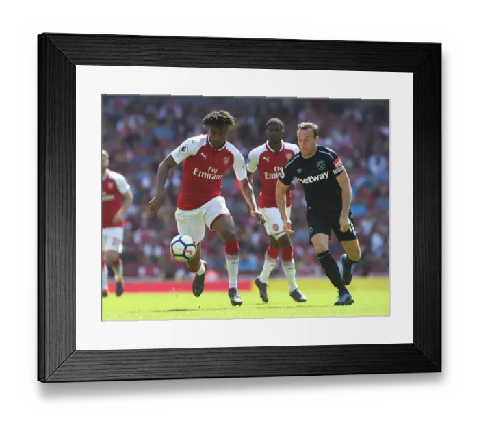 Framed Print : Arsenal's Alex Iwobi Chases Down West Ham's Mark Noble in Intense Premier League Clash