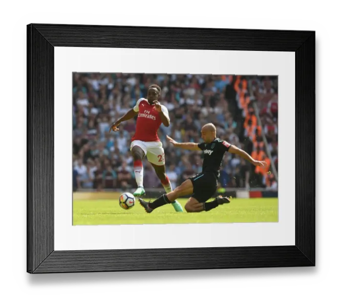 Framed Print : Arsenal vs. West Ham: Welbeck Leaps Over Zabaleta in Intense Premier League Clash