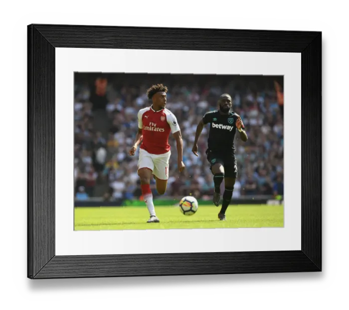 Framed Print : Arsenal's Alex Iwobi Clashes with West Ham's Arthur Masuaku in Premier League Showdown
