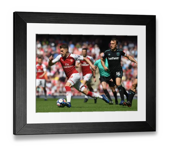 Framed Print : Arsenal's Aaron Ramsey Faces Off Against West Ham's Mark Noble in Premier League Clash