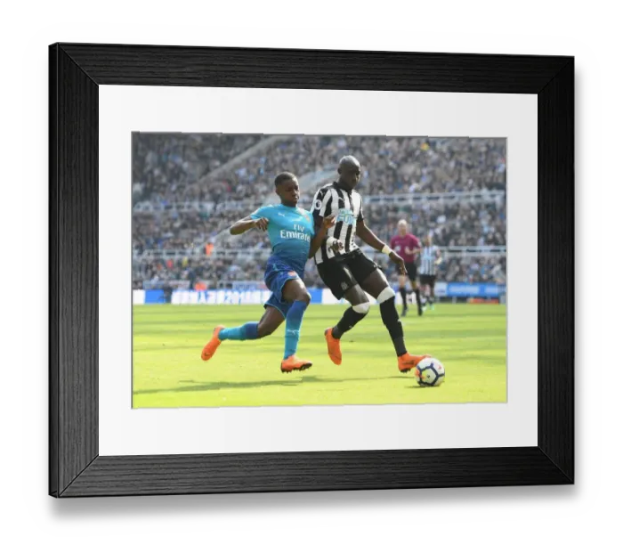 Framed Print : Clash at St. James Park: Nketiah Chases Down Diame in Premier League Showdown