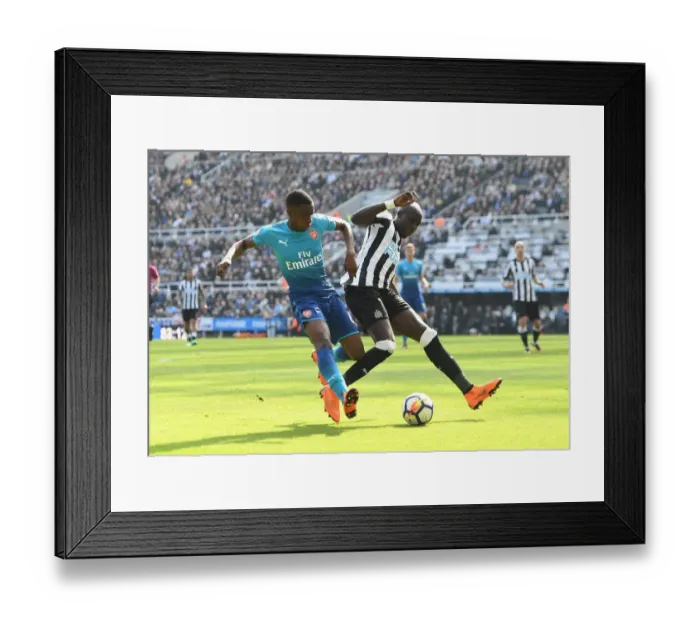 Framed Print : Eddie Nketiah Closes In on Mohamed Diame in Intense Newcastle United vs. Arsenal Clash