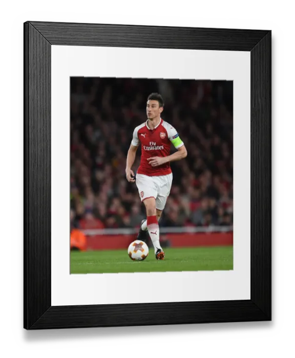 Framed Print : Arsenal's Laurent Koscielny in Action against Atletico Madrid in the Europa League Semi-Final Framed Print : Arsenal's Laurent Koscielny in Action against Atletico Madrid in the Europa League Semi-Final