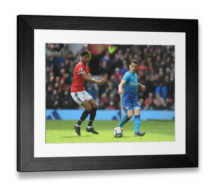 Framed Print : Xhaka vs Rashford: Intense Battle in Manchester United vs Arsenal Premier League Clash Framed Print : Xhaka vs Rashford: Intense Battle in Manchester United vs Arsenal Premier League Clash
