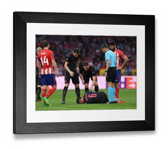 Framed Print : Arsenal's Laurent Koscielny Suffers Injury in UEFA Europa League Semi-Final vs Atletico Madrid