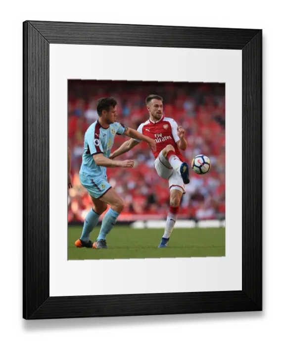 Framed Print : Arsenal's Battle at Emirates: Ramsey vs Long - A Clash of Football Fortunes