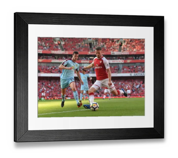 Framed Print : Arsenal's Aaron Ramsey Faces Off Against Burnley's Kevin Long in Intense Premier League Clash Framed Print : Arsenal's Aaron Ramsey Faces Off Against Burnley's Kevin Long in Intense Premier League Clash
