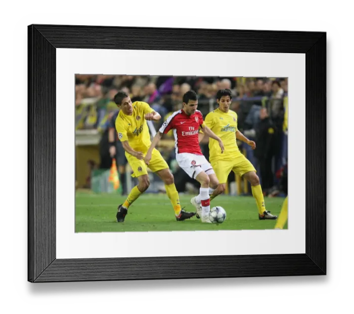 Framed Print : Cesc Fabregas Faces Off Against Sevilla's Eguren and Fernandes in Intense UEFA Champions League Quarterfinal Clash Framed Print : Cesc Fabregas Faces Off Against Sevilla's Eguren and Fernandes in Intense UEFA Champions League Quarterfinal Clash