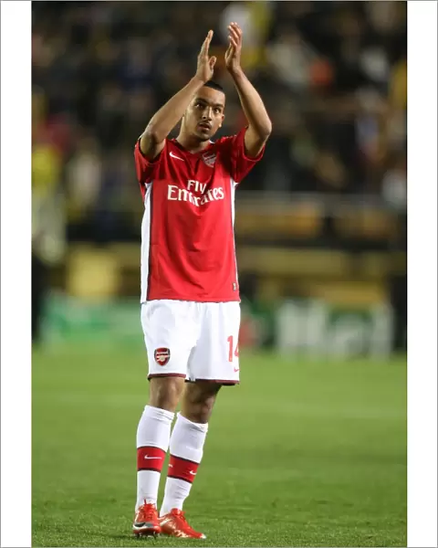 Theo Walcott waves to the Arsenal fans after the match