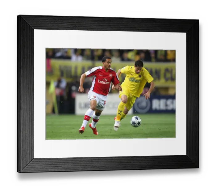 Framed Print : Theo Walcott vs. Joan Capdevila: A Battle in the Quarter Finals of the UEFA Champions League between Villarreal and Arsenal, 1st Leg at El Madrigal, 7 / 4 / 09