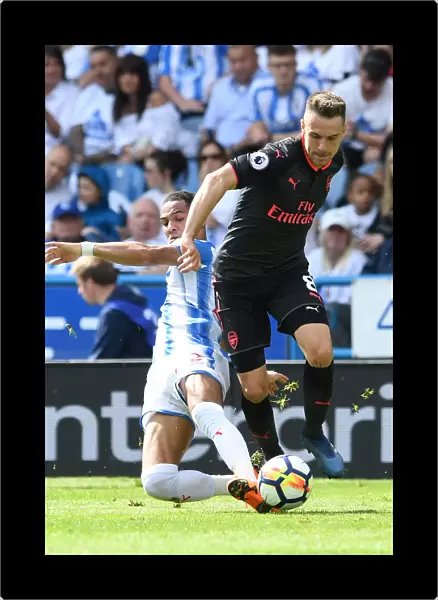 Arsenal's Aaron Ramsey Clashes with Huddersfield's Tom Ince in Premier League Showdown
