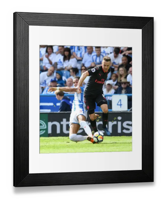 Framed Print : Arsenal's Aaron Ramsey Clashes with Huddersfield's Tom Ince in Premier League Showdown Framed Print : Arsenal's Aaron Ramsey Clashes with Huddersfield's Tom Ince in Premier League Showdown