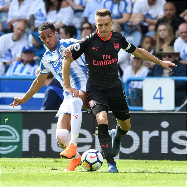Arsenal's Aaron Ramsey Faces Off Against Huddersfield's Tom Ince in Premier League Clash
