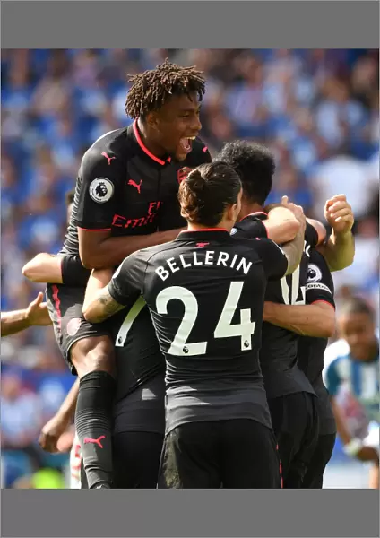 Arsenal's Triumph: Aubameyang, Iwobi, and Bellerin in Unison after Scoring against Huddersfield Town
