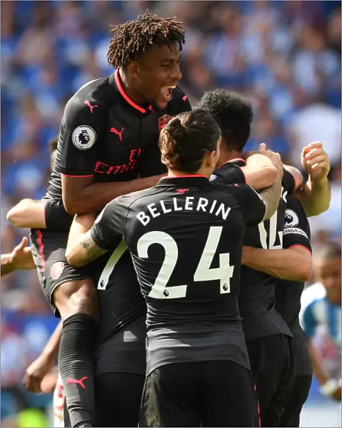 Arsenal's Triumph: Aubameyang, Iwobi, and Bellerin in Unison after Scoring against Huddersfield Town