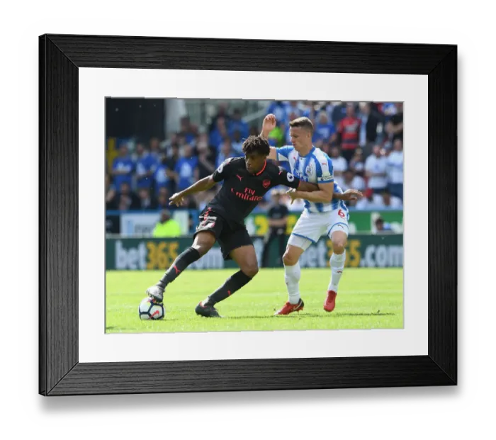 Framed Print : Arsenal's Alex Iwobi Fends Off Huddersfield's Jonathan Hogg During Premier League Clash