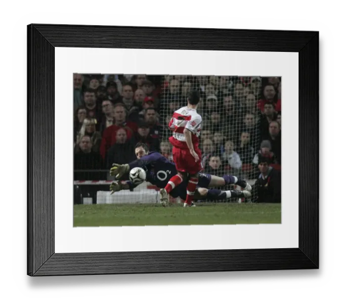 Framed Print : I. Manuel Almunia (Arsenal) saves at the feet of Lewis Guy (Doncaster)