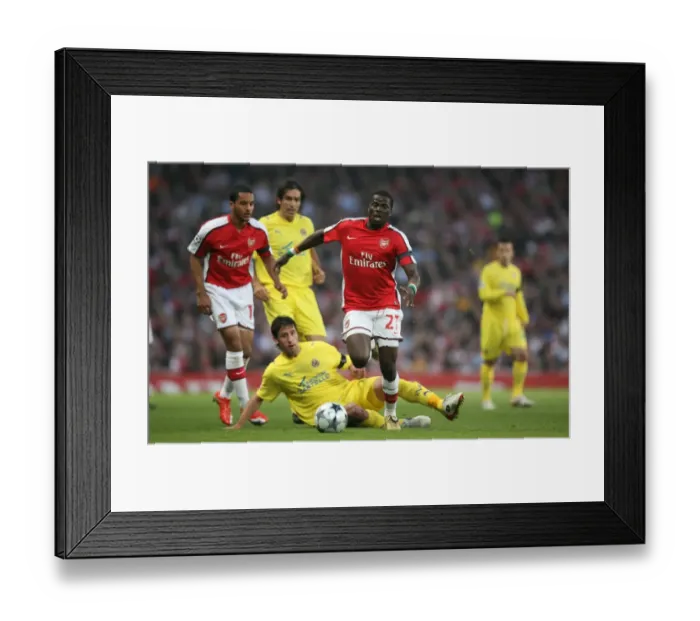 Framed Print : Arsenal's Eboue and Capdevila Clash in Champions League Semi-Final Showdown: Arsenal 3-0 Villarreal (15 / 4 / 2009)