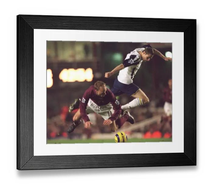 Framed Print : Dennis Bergkamp (Arsenal) Brian Priske (Portsmouth). Arsenal 4: 0 Portsmouth