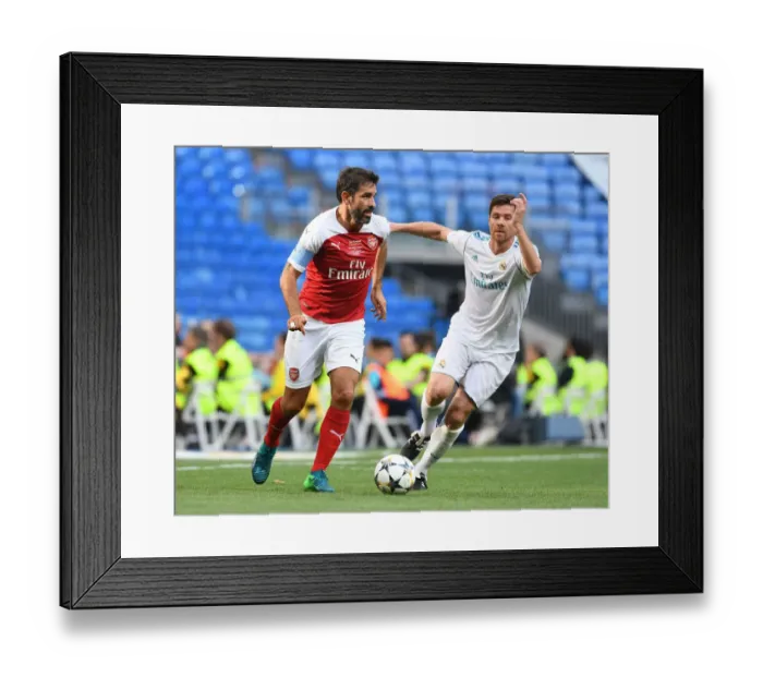 Framed Print : Pires vs. Xavi: A Legendary Clash between Real Madrid and Arsenal Framed Print : Pires vs. Xavi: A Legendary Clash between Real Madrid and Arsenal