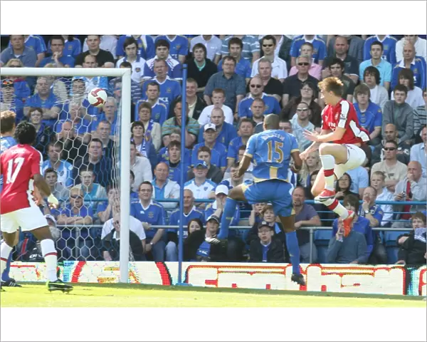 Nicklas Bendtner heads past Portsmouth goalkeeper David