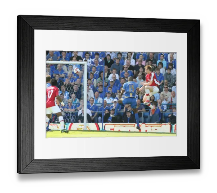 Framed Print : Nicklas Bendtner heads past Portsmouth goalkeeper David