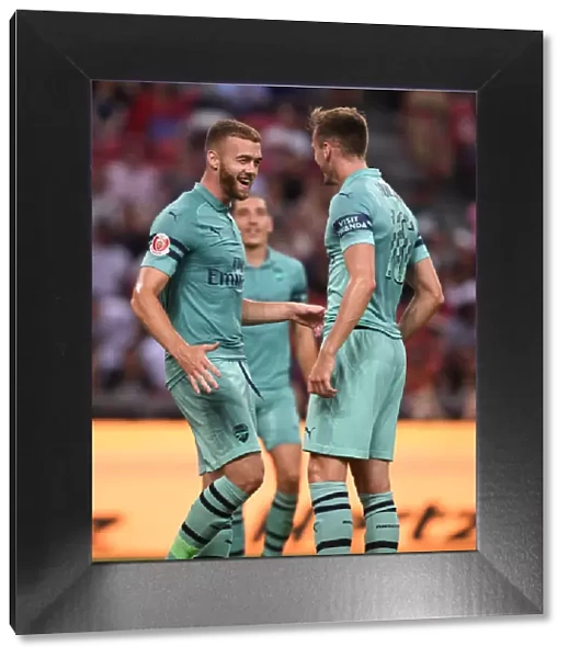 Arsenal's Holding and Chambers Celebrate Goal Against Paris Saint-Germain in 2018 International Champions Cup